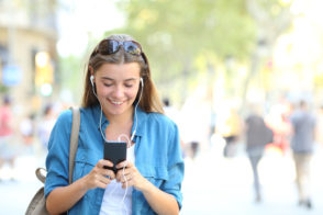 Happy girl listening to music using a phone